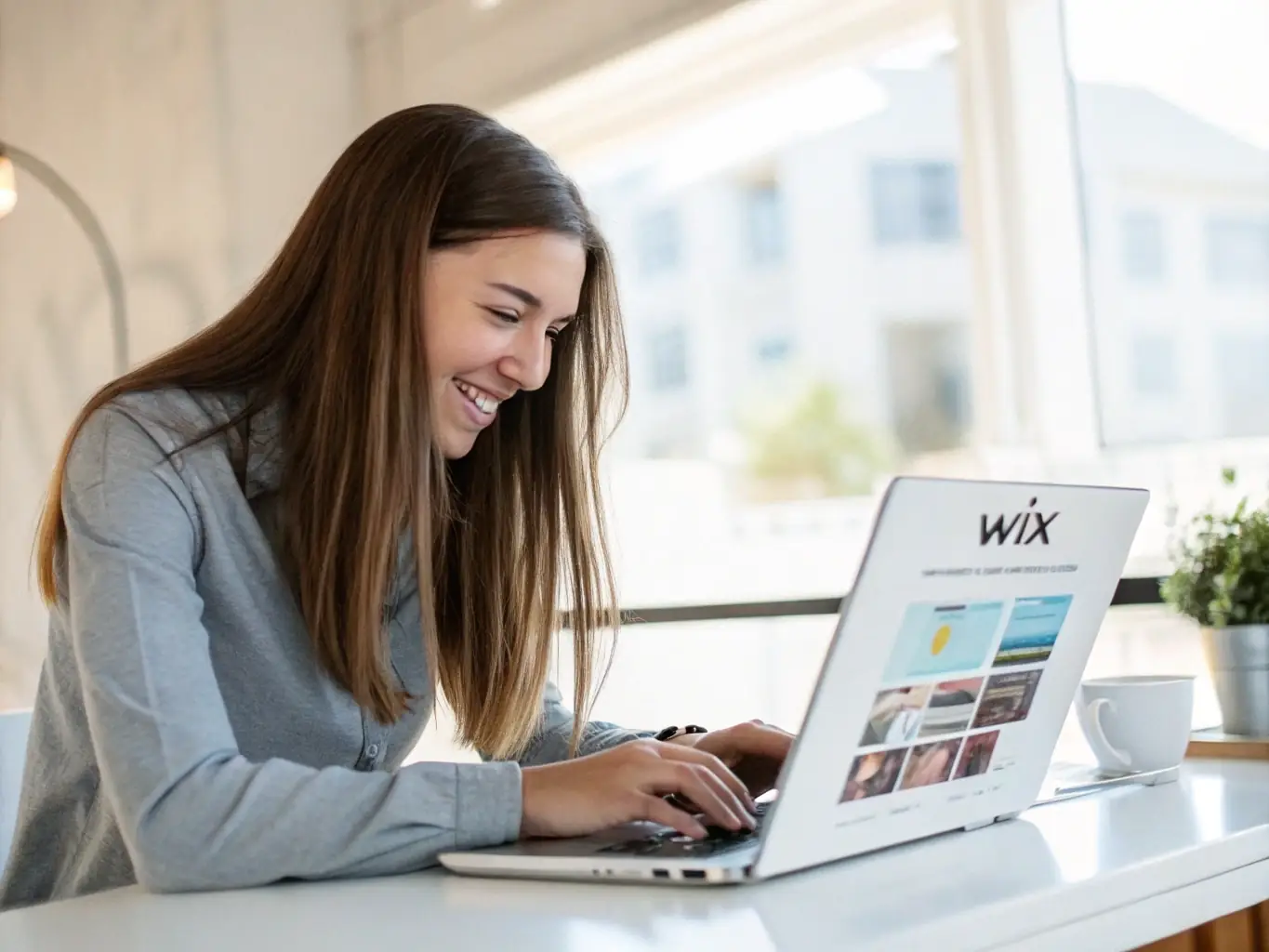 A person smiling and easily dragging and dropping elements on a website template within the AI Website Creator interface on a desktop computer, showcasing the user-friendly design process.